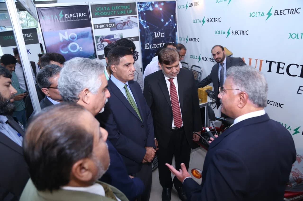 Academic leaders inspecting the converted electric bike